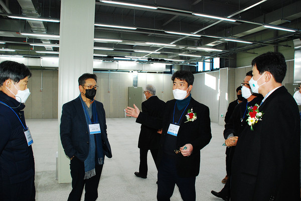 김용수 하스 대표(좌부터 4번째)가 제2공장 내부에서 관계자들에게 안내하고 있다